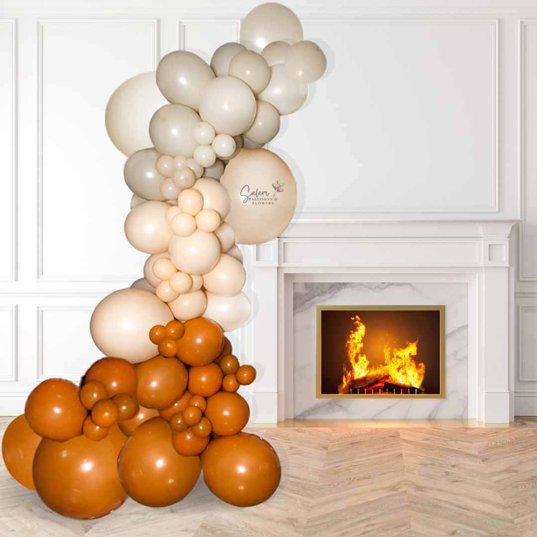 14 foot organic balloon garland in orange, blush and sand colors installed on a front porch. Size chart. Salem Oregon balloon decor.