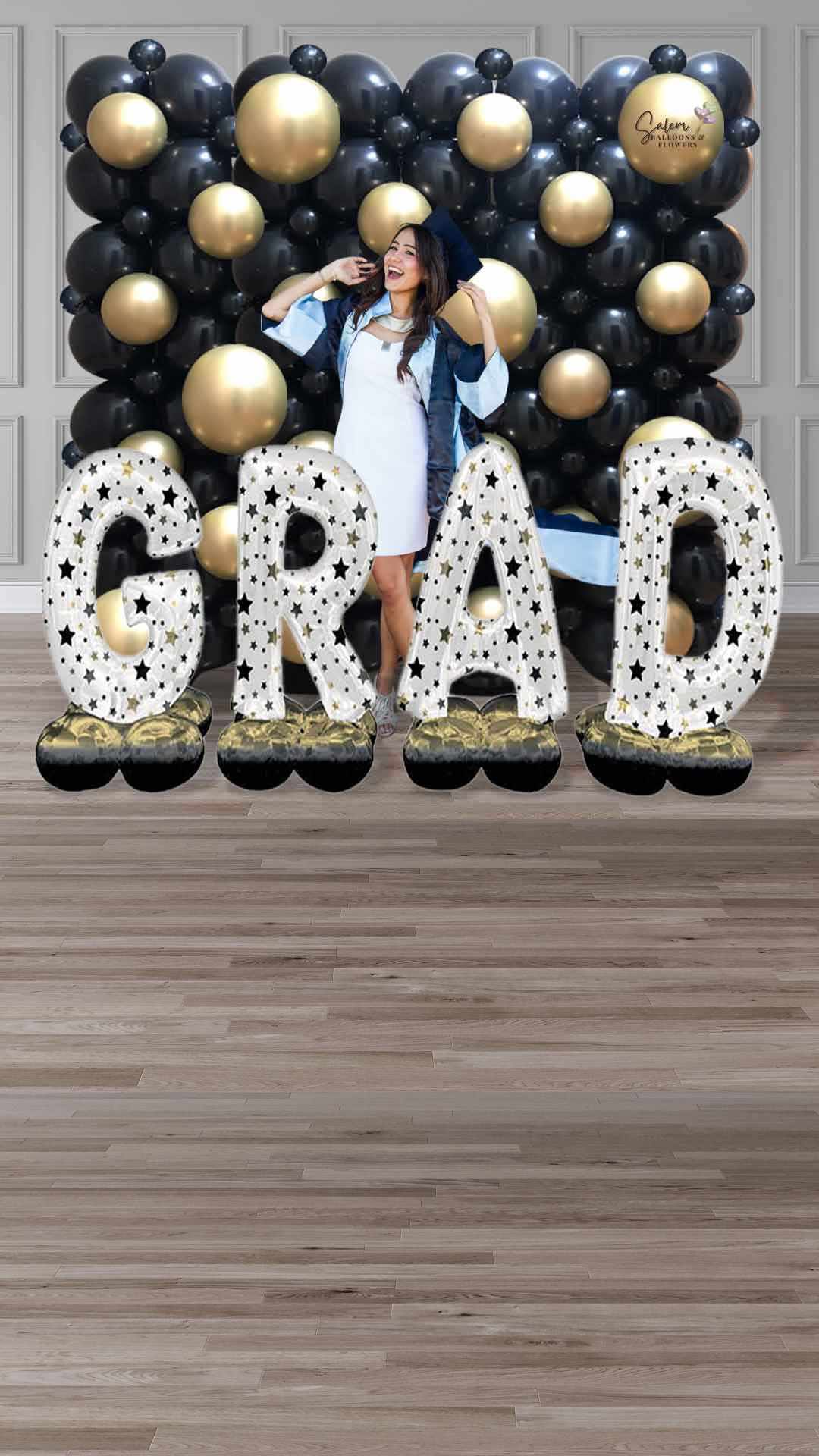 A girl standing in front of a Grad balloon wall decoration. Salem Oregon balloon decor.