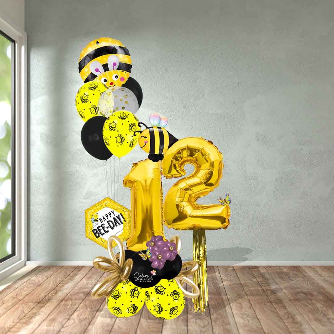 Bee-themed balloon bouquet with gold balloon numbers and a happy bee-day message. Delivery in Salem Oregon and nearby cities. Balloon decorations