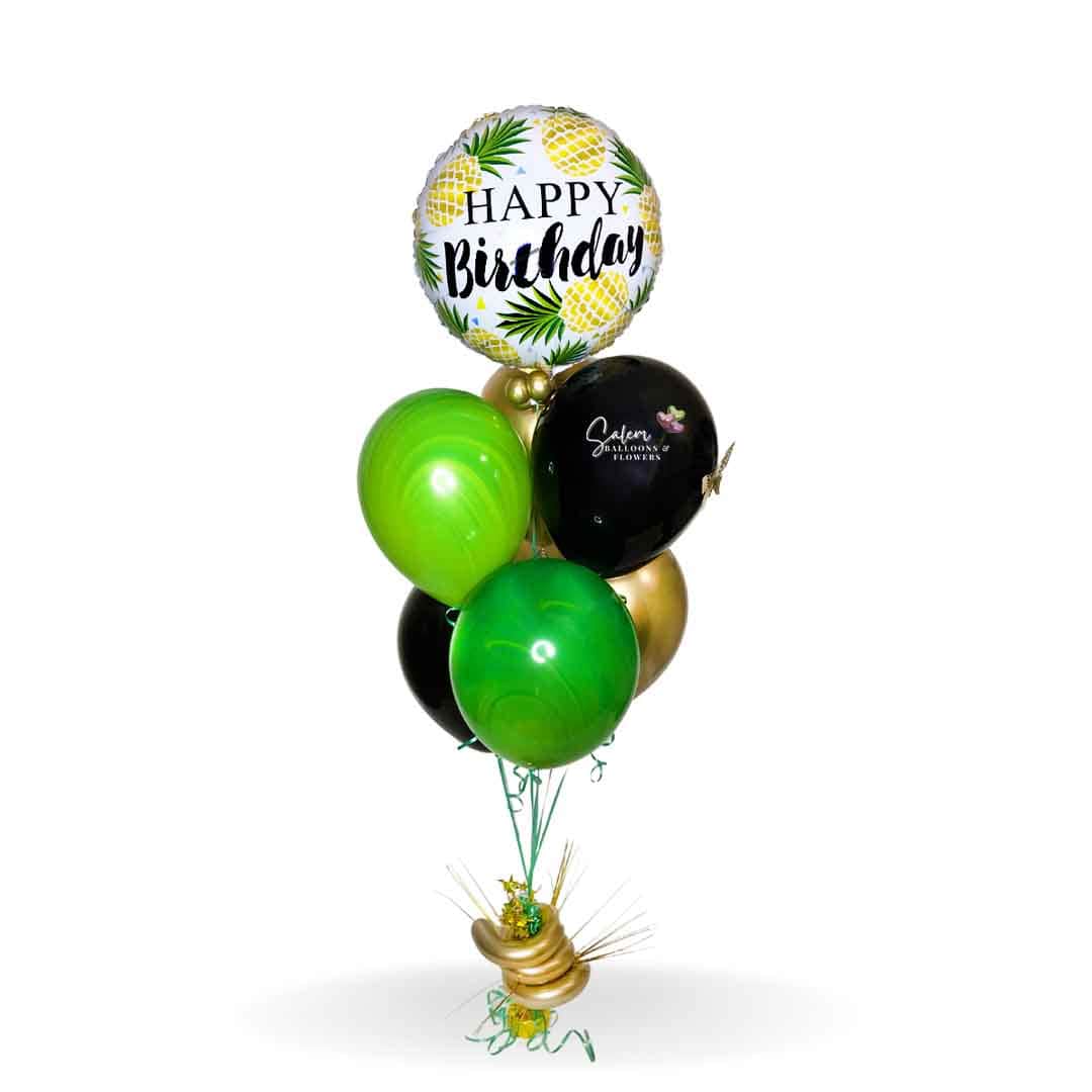 HBD tropical balloon bouquet. Featuring a pineapple themed Mylar balloons with a Happy Birthday message and a set of bright colored helium balloons, anchored to a decorated weight. Balloons Salem Oregon and nearby cities.