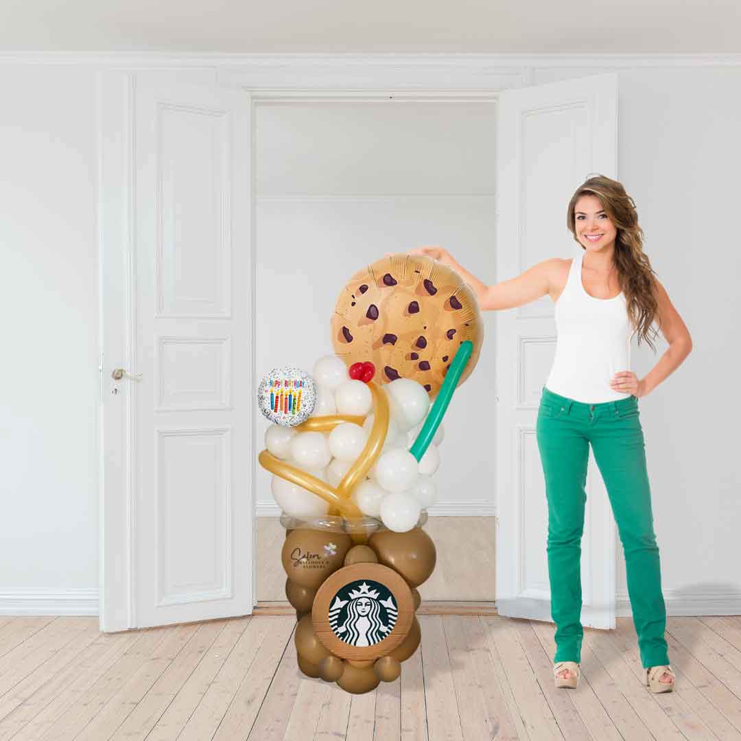 a young girl standing next to a 4 Ft tall Starbucks Latte inspired balloon bouquet. with whipping cream and a chocolate cookie balloon. Delivery in Salem Oregon and nearby cities.