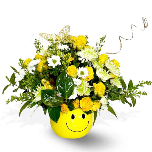 Smiley-face yellow vase with yellow spray roses and white flowers and greenery. Decorated with golden twicks and butterfly. Salem Oregon Flower Delivery.
Birthdays, get well or just because.