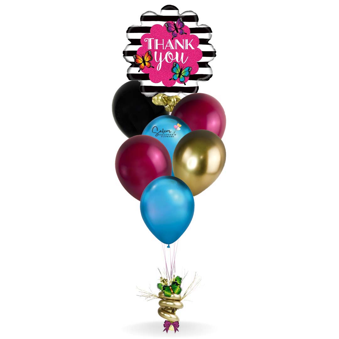 Thank You balloon bouquet. Featuring a black and white strips with colorful butterflies and a Thank You message balloon plus a set of colorful helium balloons anchored to a decorated weight. Deluxe style comes with a box of chocolates and free delivery.