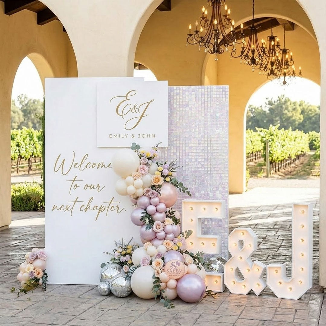 A luxury wedding welcome sign display at an Oregon vineyard venue entrance, featuring a large white backdrop panel