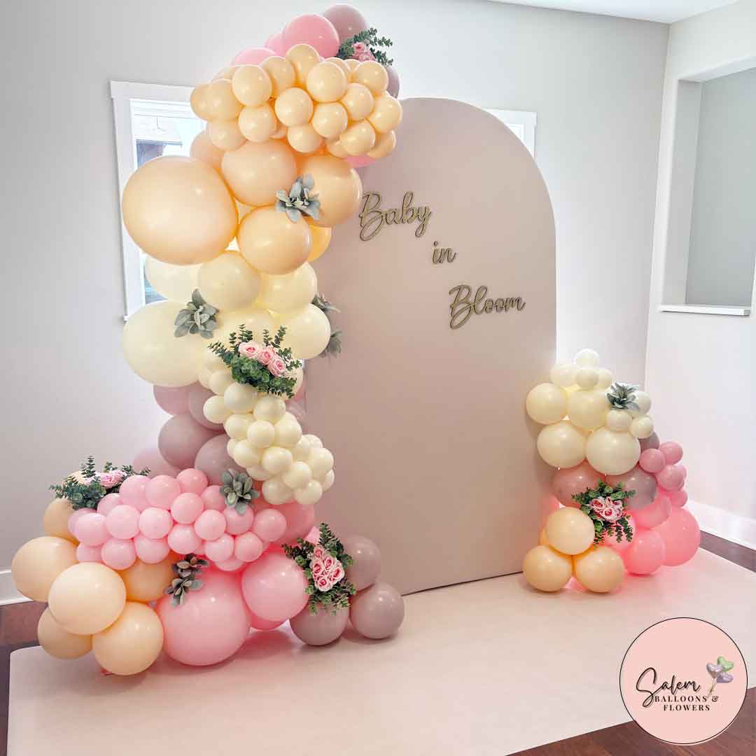 Butterfly themed Balloon decor in pink with 2 Solid color chiara panels with 2 balloon garlands, cake stands and marquee number. Balloon Decor. Oregon.