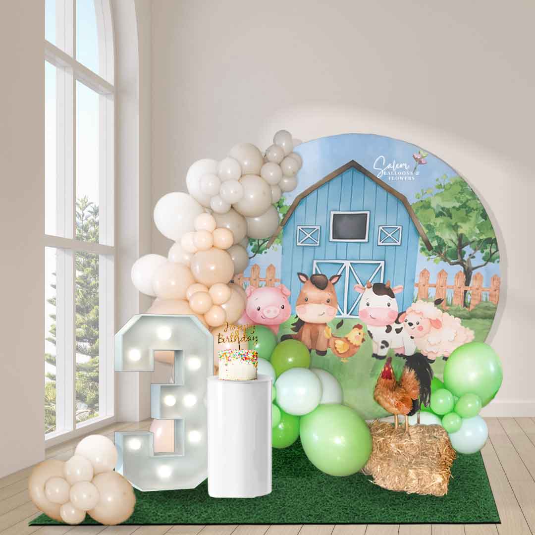 Farm-themed balloon decor with a hoop backdrop, marquee number, cake pedestal and balloon garlands. Salem Oregon Balloon Decor. 