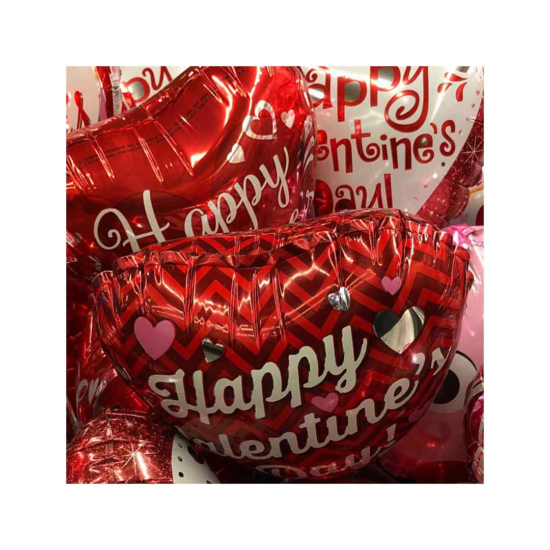 Girl holding an XL ping grog plush with a "You make my heart leap" message embroidered, holding a set of Valentine's Day Balloon bouquet. Salem Oregon balloon delivery