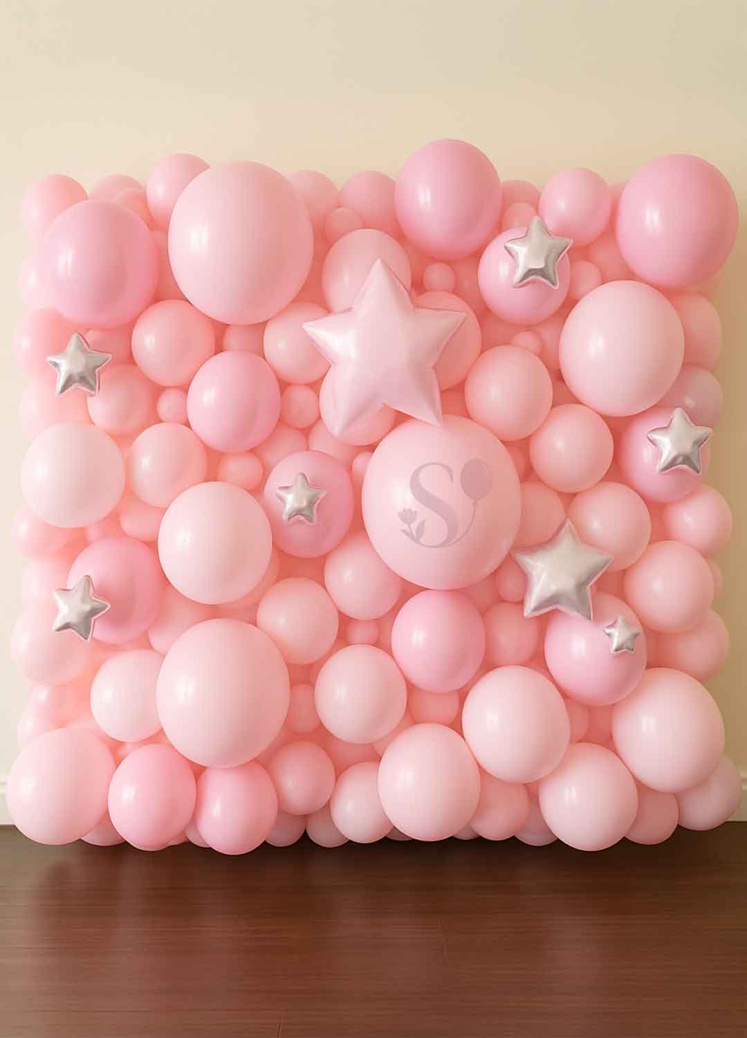 Organic balloon wall in pastel pink in front of a cream wall. Oregon