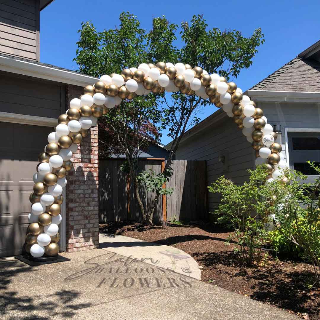 White and Gold Balloon Arch decorating a house backyard entrance. Salem Oregon Balloon decor. Balloon decorations Oregon.
