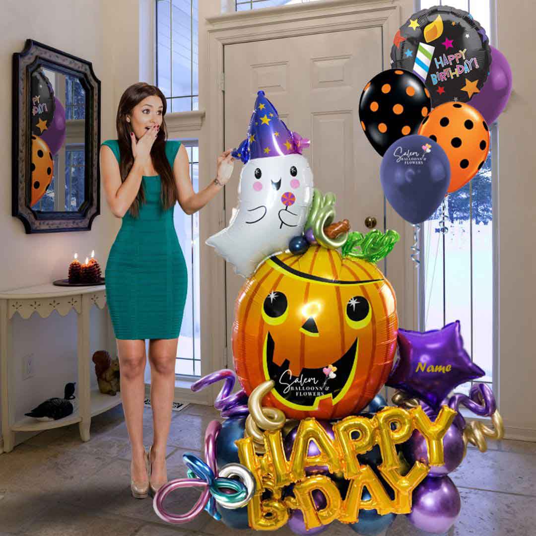Young girl standing next to a halloween themed balloon bouquet. Oregon balloon delivery.