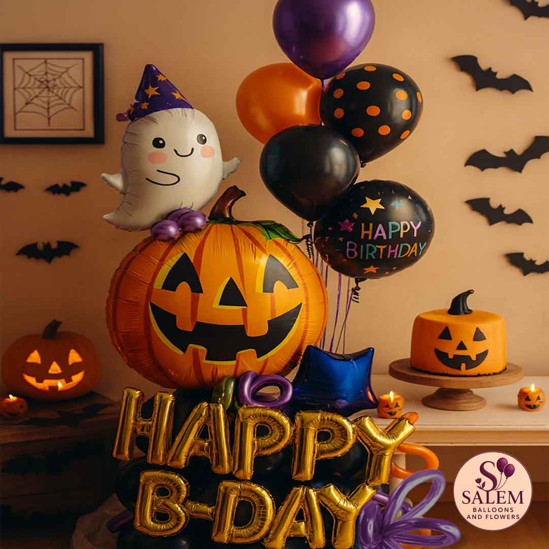 Halloween-themed birthday decorations with balloons, cake, and pumpkins on a table. Oregon Birthday balloon delivery.