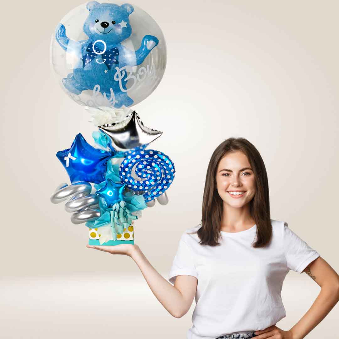A girl holding a Baby Boy themed balloon bouquet with a stuffed bubble balloon. Delivery in Salem Oregon and nearby cities.