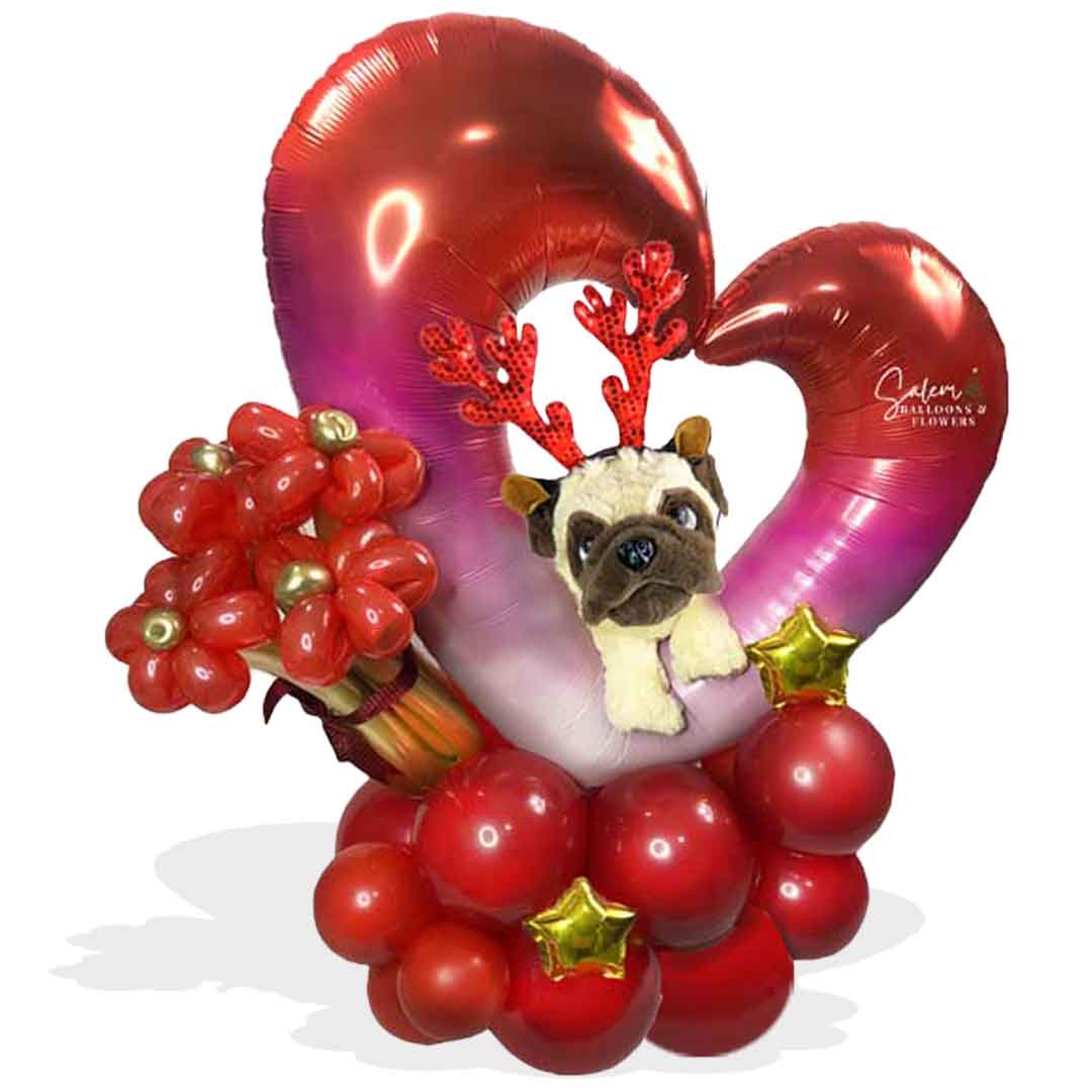 Pug puppy poking through a decadent open heart adorned with peppermint-style balloons and helium balloons. Balloons Salem Oregon