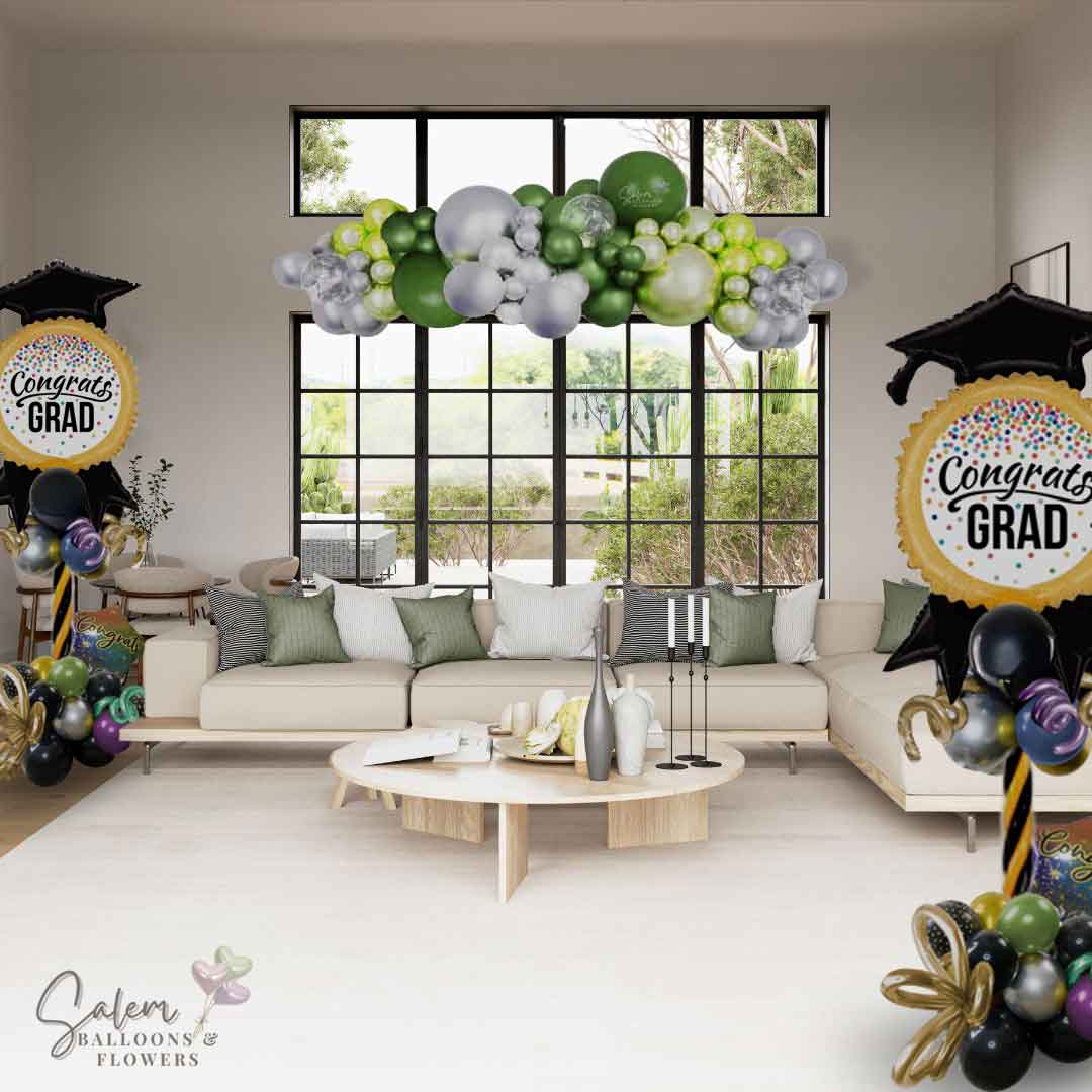 2 large "Congrats Grad" colorful balloon columns decorating a Living Room along with a balloon garland on a window. Balloon Decor. Oregon.