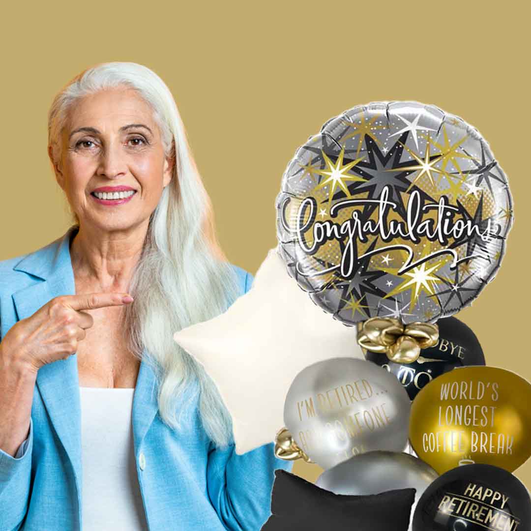 Lady pointing at Congratulations on your retirement balloon bouquet. in silver black and gold color balloons. Salem Keizer oregon balloon delivery
