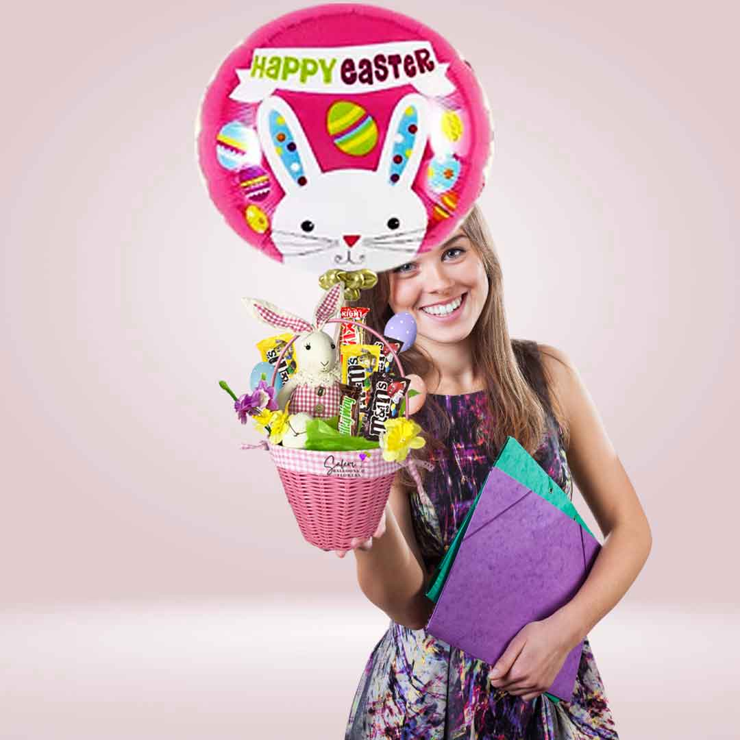 girl holding a gorgeous Easter pink basket filled with a delicious assortment of Chocolates. Featuring an adorable bunny and an Easter themed Mylar balloon. Delivery available in Salem OR and nearby cities.