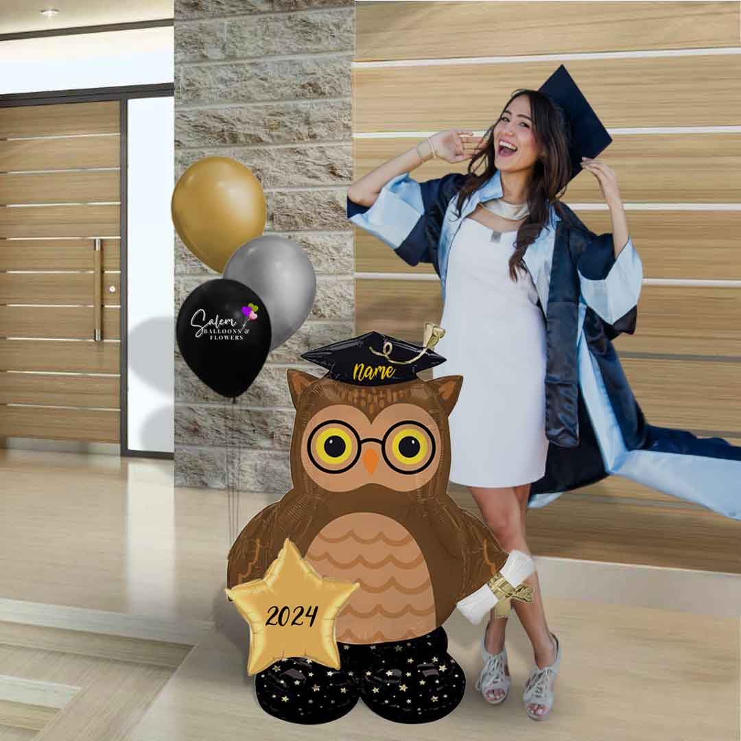 A grad girl standing next to an Extra large Grad Owl balloon with a set of helium balloons. Salem Oregon Balloon decorations