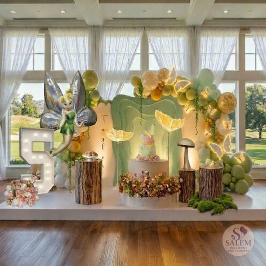 Fairy themed balloon decoration with 3 panels and balloon decor with lit butterflies, decorated with flowers and balloon garlands, lit Marquee number 5 in a room with large windows. Luxury balloon decor. Oregon.