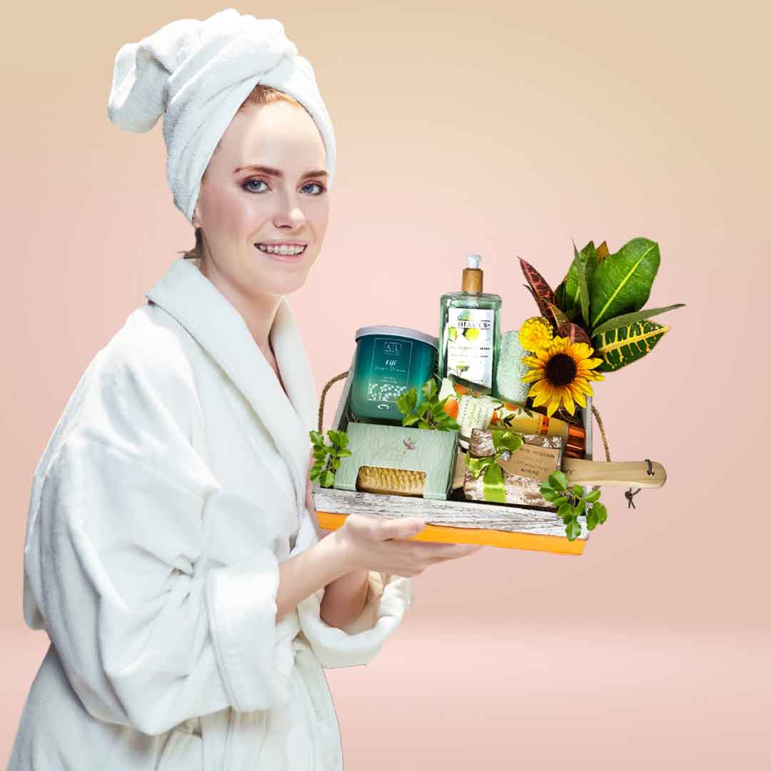 lady on a white rob holding a spa wooden box. Spa box gif delivery in Salem Oregon and nearby cities.