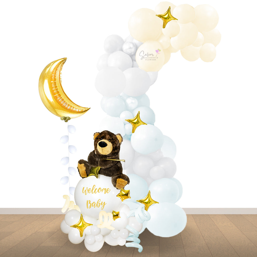 a teddy bear plush fishing stars on a balloon bouquet and a balloon barland in pastel colors. A moon balloon floats next  this balloon decoration. Salem oregon balloon decor