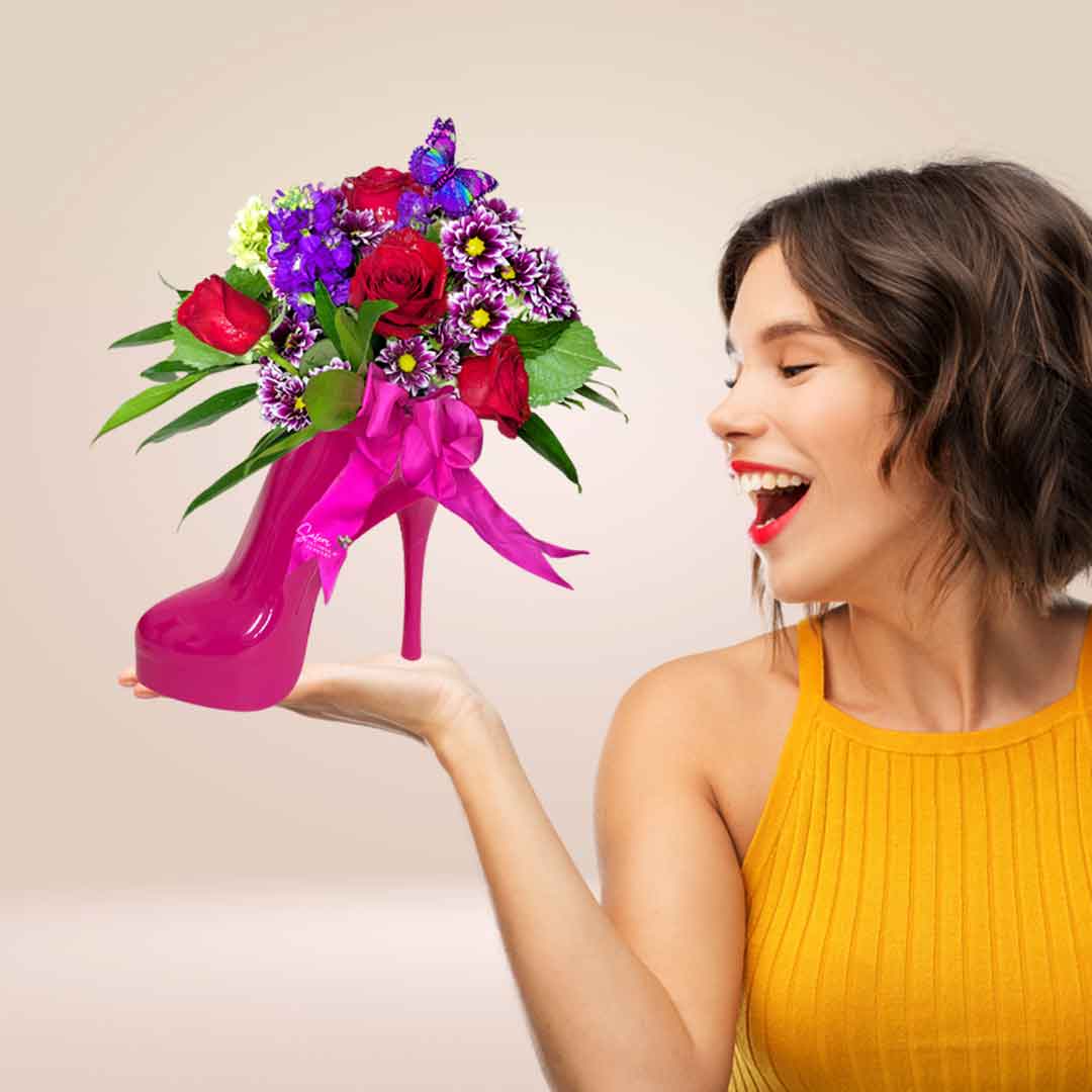 Woman holding a flower arrangement in a pink barbie shoe vase. Salem Oregon flower delivery