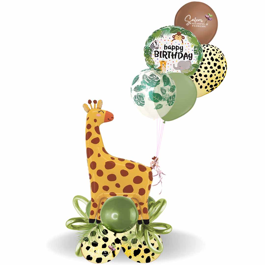 Safari themed balloon bouquet featuring a larg Giraf balloon standing on a balloon base with palm leaves and balloon bows and a set of helium balloons. Balloons Salem Oregon