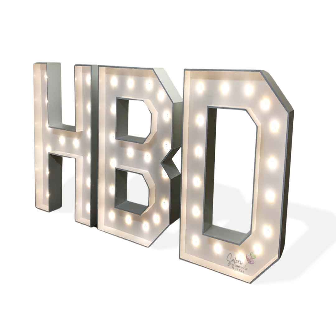 4 Ft tall White light-up HBD marquee letters standing on a white floor. Salem Oregon Balloon decor