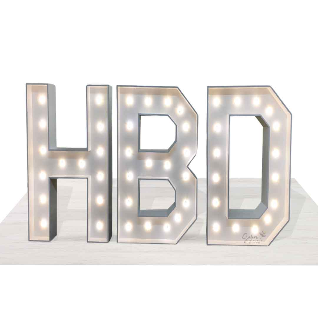 White light-up HBD marquee letters standing on a white floor. Salem Oregon Balloon decor