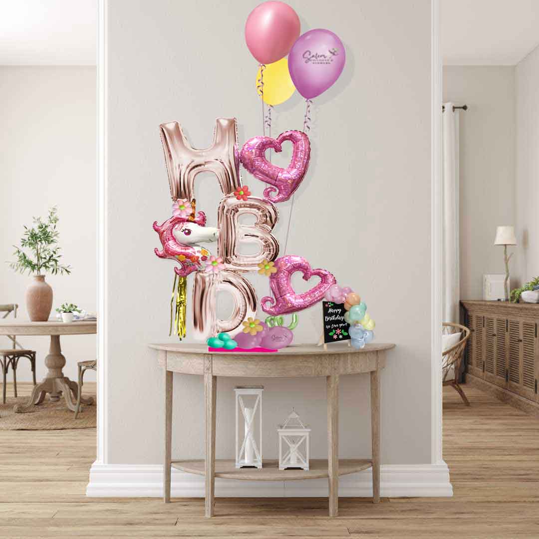 HBD letters balloon arrangement featuring a unicorn in a pink variety of colors and a set of helium balloons. Balloon salem Oregon. Size chart.