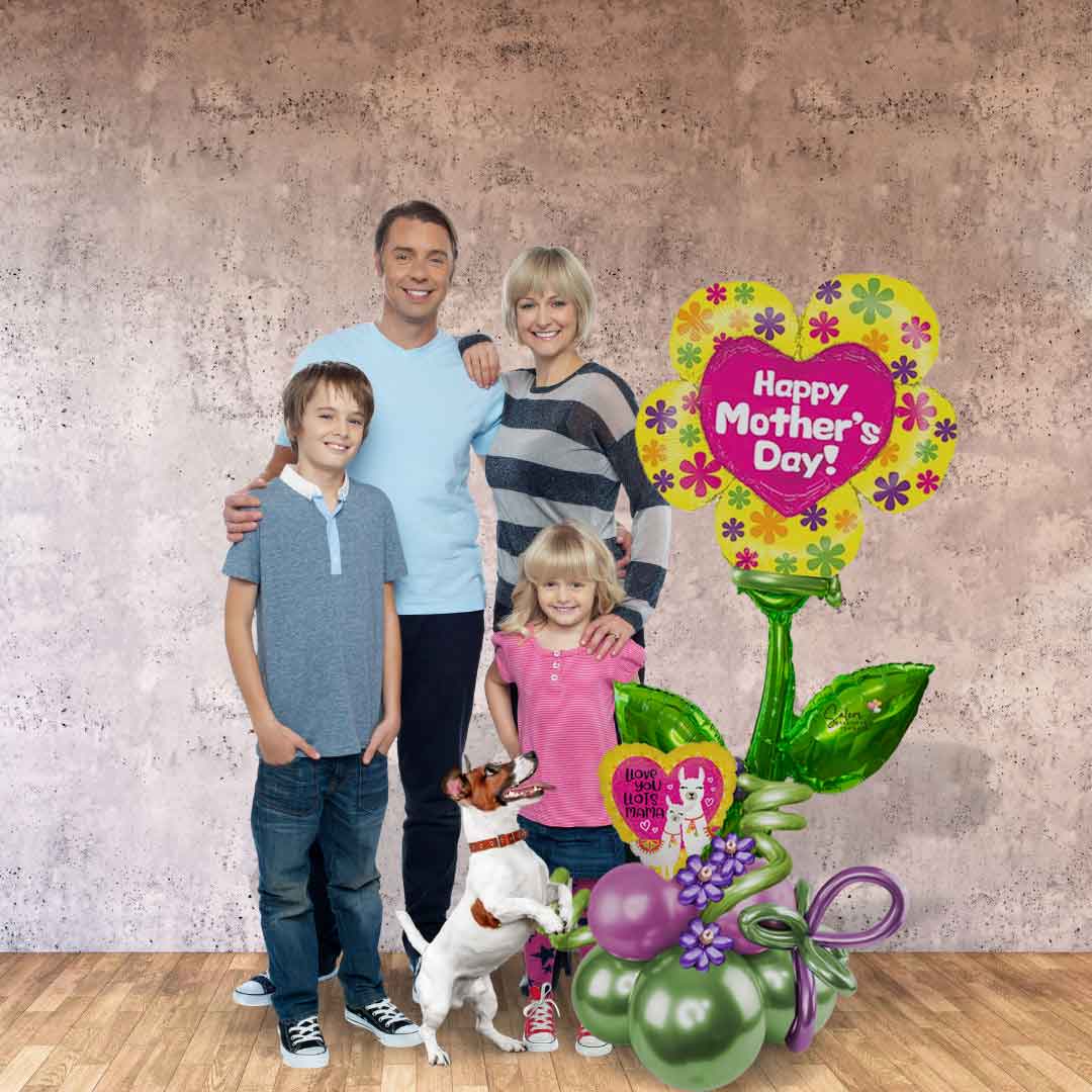 A family posing next to a Mega Size Happy Mother's Day Balloon Bouquet. Featuring an extra large Flower Pick balloon with a 
