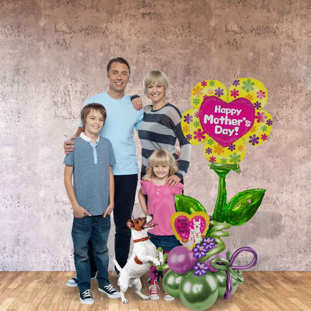 A family posing next to a Mega Size Happy Mother's Day Balloon Bouquet. Featuring an extra large Flower Pick balloon with a "Happy Mother's Day" message standing on a handcrafted balloon base made with complementary colors and curly balloons.Salem Oregon balloon delivery.