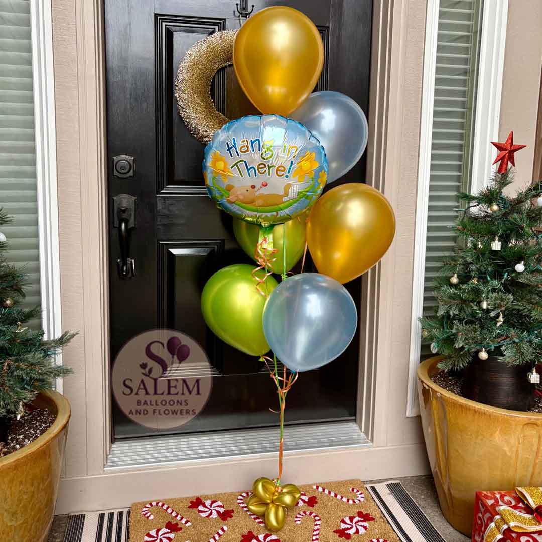 Decorative balloons with a greeting in front of a door, with 'Salem Balloons & Flowers' branding.