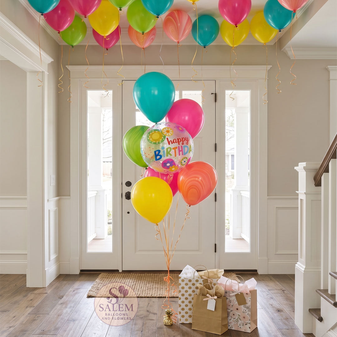 Colorful balloons bouquet with a 'Happy Birthday' balloon in a home entrance setting. Birthday balloon delivery. oregon.