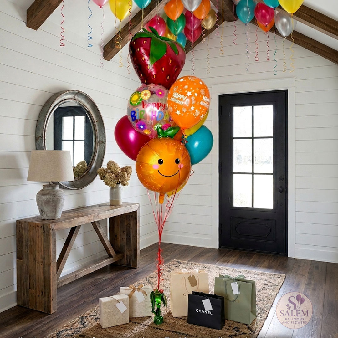 Colorful balloon bouquet with fruit shapes on a farmhouse foyer, featuring the Salem Balloons & Flowers logo. Birthday Balloon delivery. Oregon