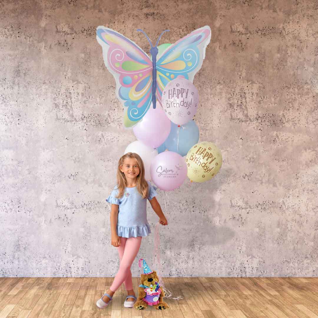 A little girl holding an extra tall butterfly themed balloon bouquet in pastel colors. Salem Oregon balloon delivery.