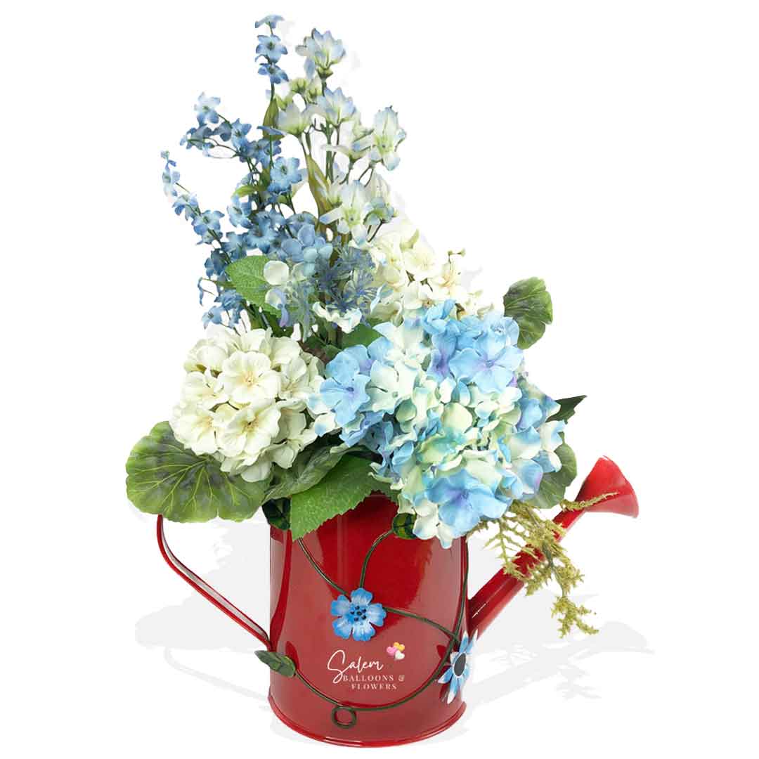 Hydrangeas flower arrangement in a decorative red water can. Flower delivery in Salem Oregon