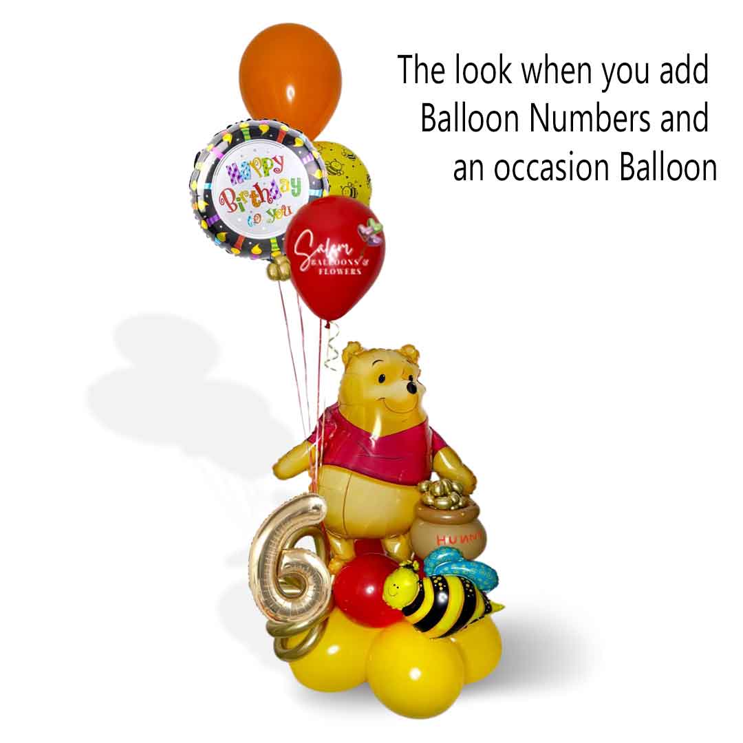 a Winnie the Pooh themed balloon bouquet with a large Winnie mylar balloon holding a honey pot filled with honey and bees, a balloon number and a happy birthday balloon
.  Oregon Balloon Delivery.