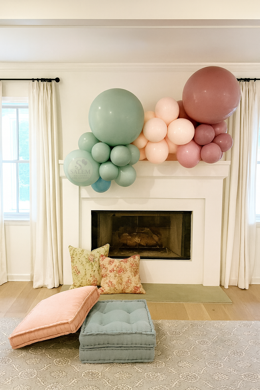 Pastel color organic balloon garland on a fireplace in a living room  with a Salem Balloons and flowers logo. 