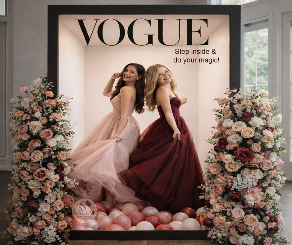 Vogue magazine cover photo booth with two young girls wearing prom dresses, surrounded by flowers and decor. Party Rentals. Oregon.
