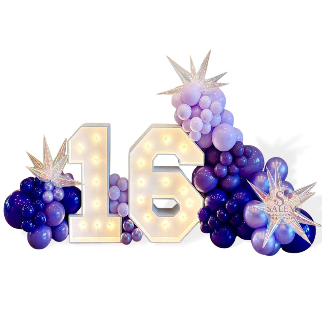 Architectural marquee number display featuring warm-white bulbs and professional balloon styling in a deep violet palette, curated by Salem Balloons and Flowers in McMinnville.