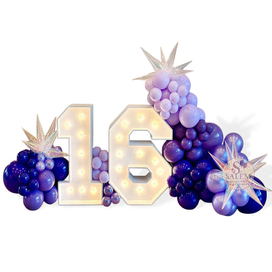 Architectural marquee number display featuring warm-white bulbs and professional balloon styling in a deep violet palette, curated by Salem Balloons and Flowers in McMinnville.