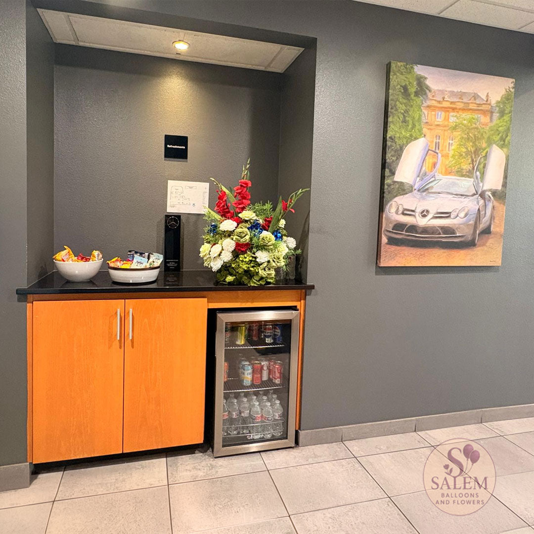 Flower arrangement to decorate the Mercedes Benz of Salem concession room by Salem Balloons and Flowers.