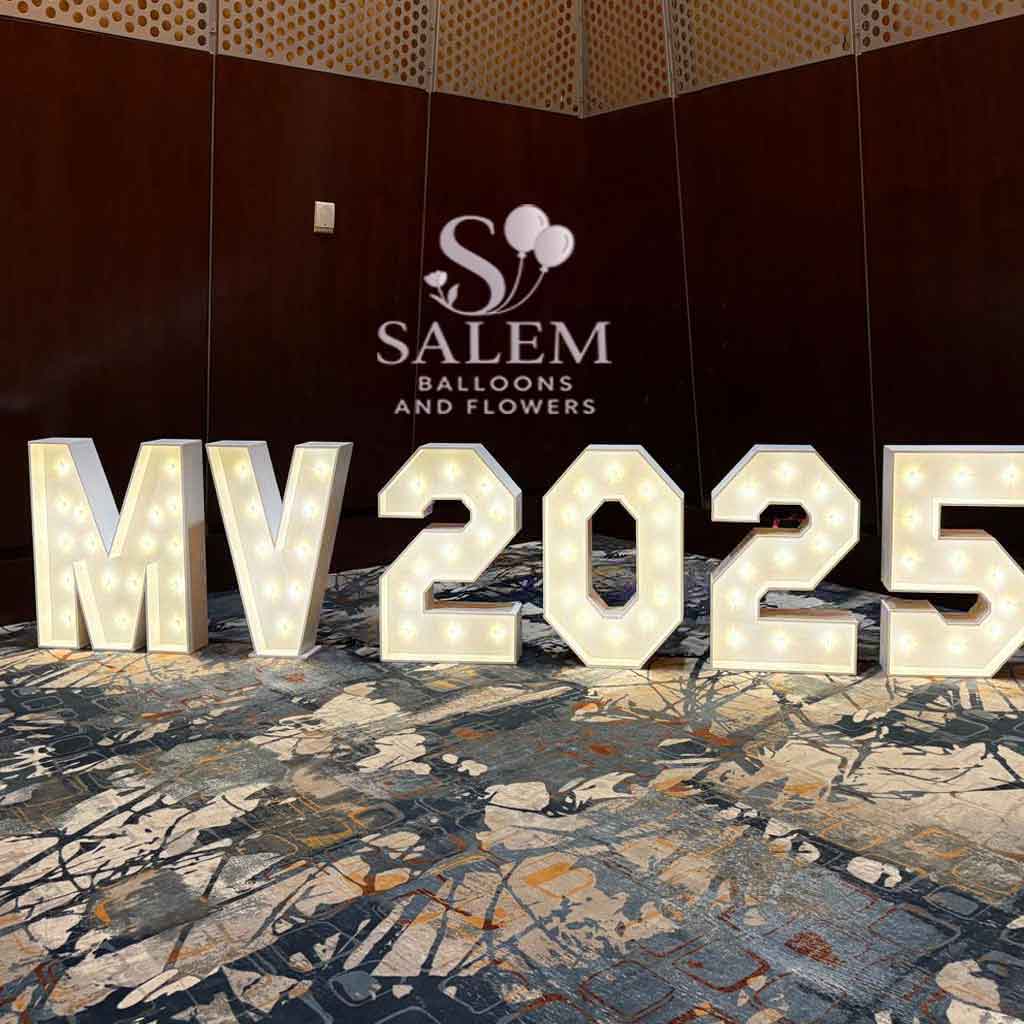 Decorative letters 'MV2025' with lights on a patterned floor, brand 'Salem Balloons & Flowers' visible. Oregon party rental.