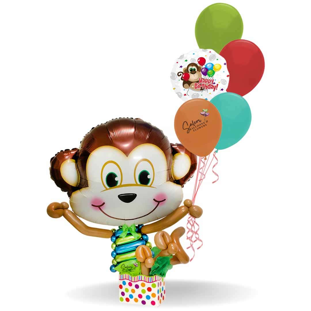 A big moneky balloon falling in a colorful polkadots box as he holds a set of helium filled balloons. Balloon delivery Salem Oregon and nearby cities.