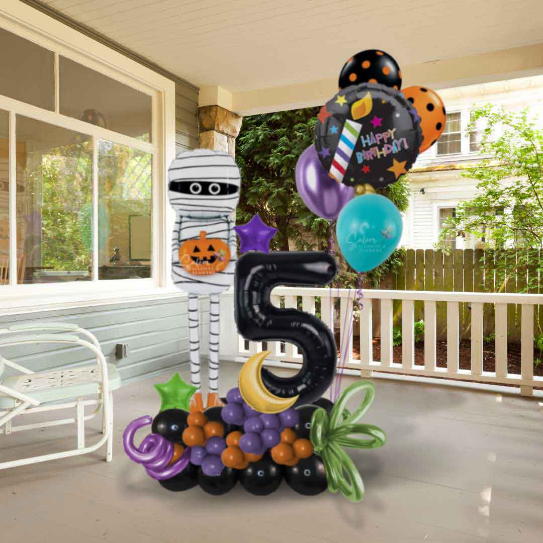 Number balloon arrangement with a mummy balloon standing in a porch. Balloon delivery Oregon