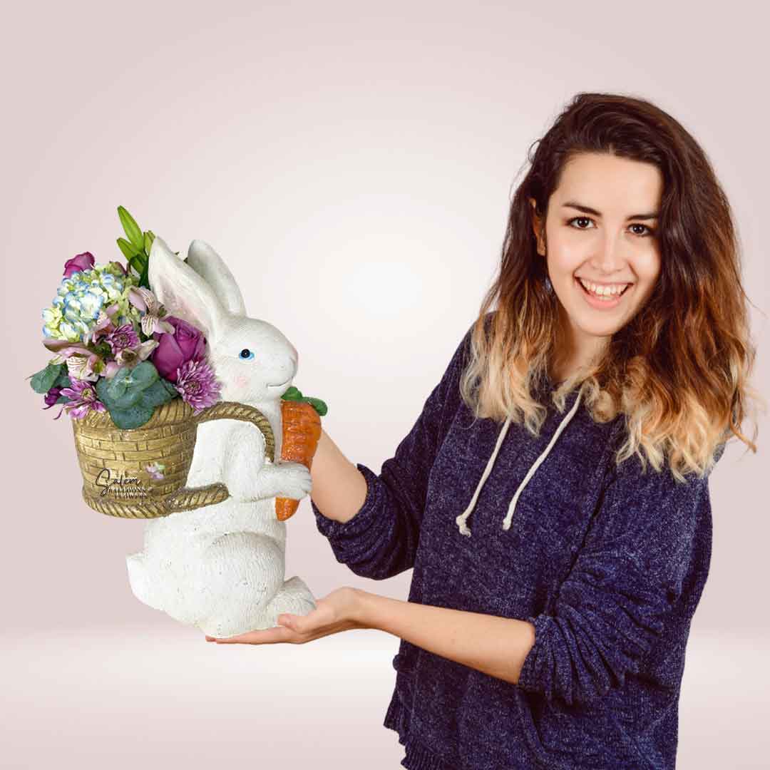 Woman holding a Spring flower arrangement in a large white bunny vase. Flower delivery in Salem Oregon and nearby cities.