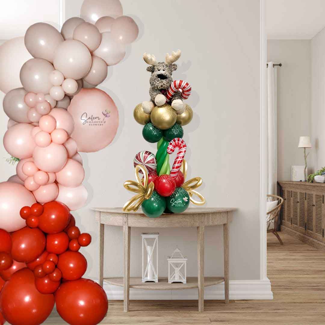 Christmas Balloons Salem ORegon. Christmas balloon column with a reindeer plush topper. On site size chart picture.