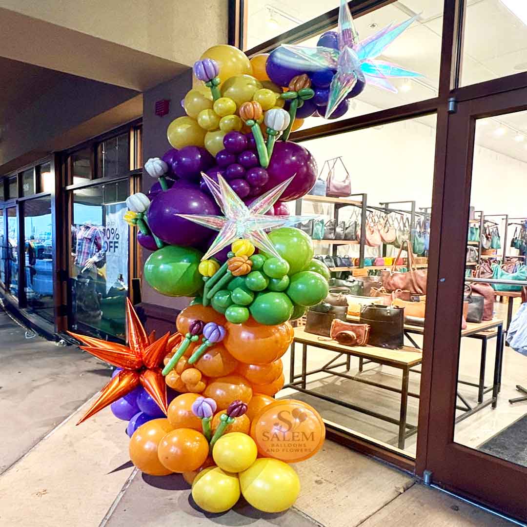 Colorful Organic balloon garland with balloon tulips to decorate the Portland Leather Goods store in Woodburn, OR.