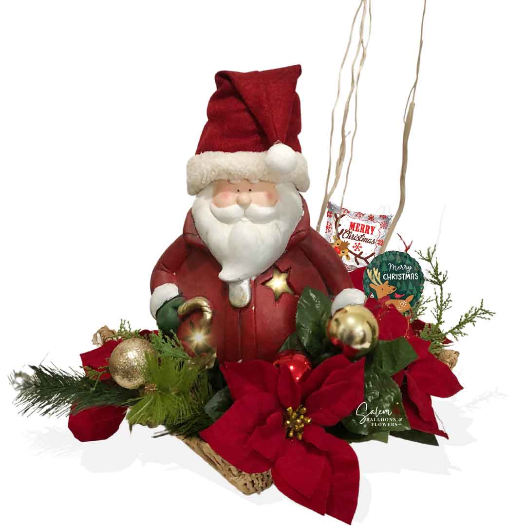 Papa Noel, flower and balloon arrangement, Featuring a lighted ceramic Santa, petite Christmas balloons, lush poinsettia flowers, and ornate decorations. Flowers Salem Oregon. Balloons Salem Oregon.