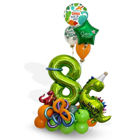 A Dinosaur-themed number balloon bouquet. Featuring Dinosaur shaped balloons, 1 large number balloon and a helium balloon bouquet, standing in front of a door. Approx 7 ft Tall. Oregon Balloon Delivery.